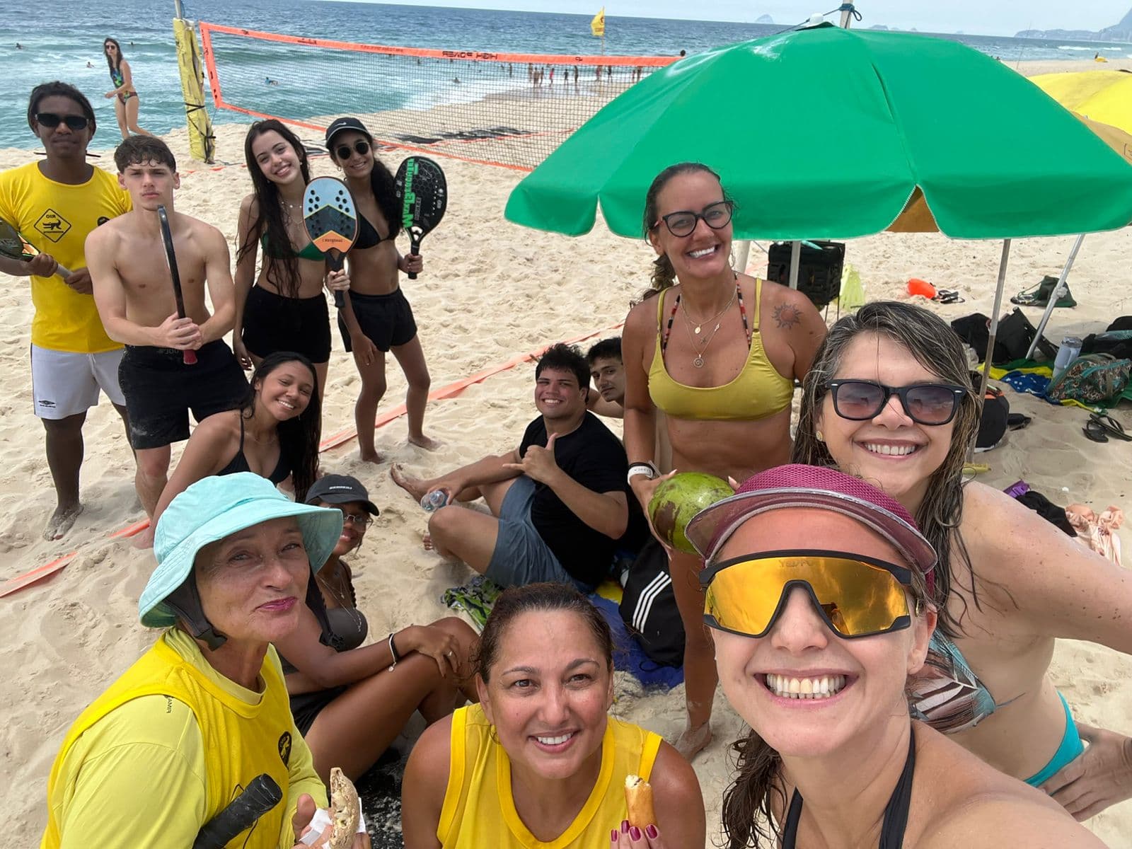 Maicon Cândido with a group gathered after a beach tennis activity